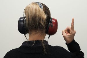 Speech pathology uses headphone to help individual.