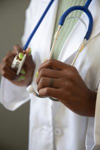 A physician is wearing a stethoscope